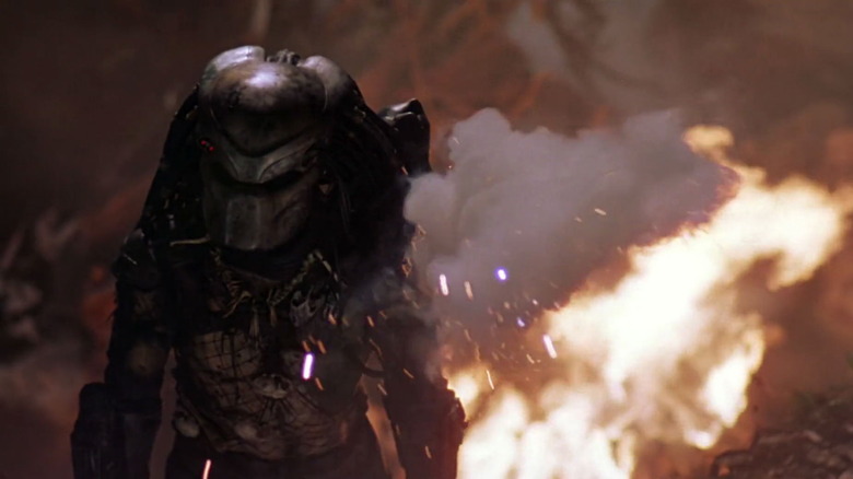 The hunter standing in front of flames in Predator