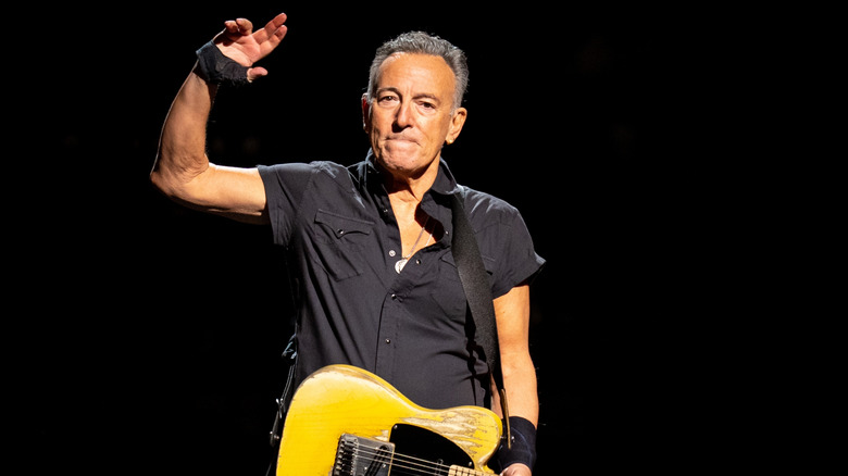 Bruce Springsteen holding a guitar on stage