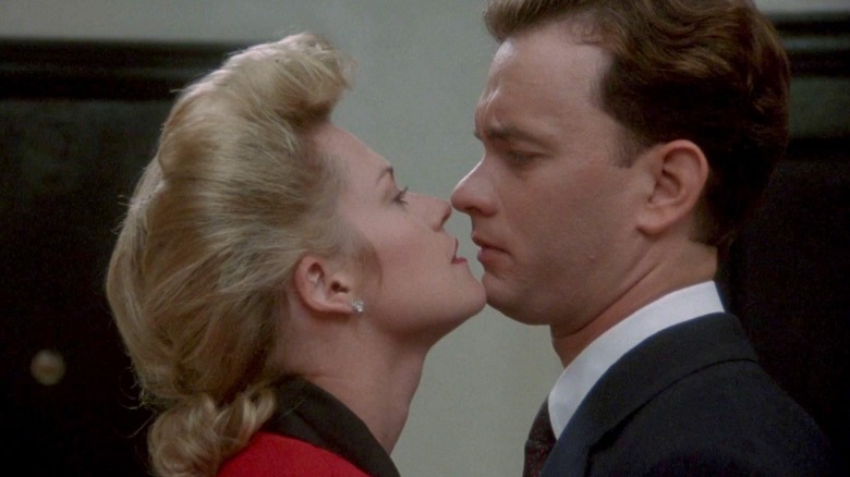 Tom Hanks as Sherman being reluctantly kissed by Melanie Griffith as his mistress Maria in The Bonfire of the Vanities