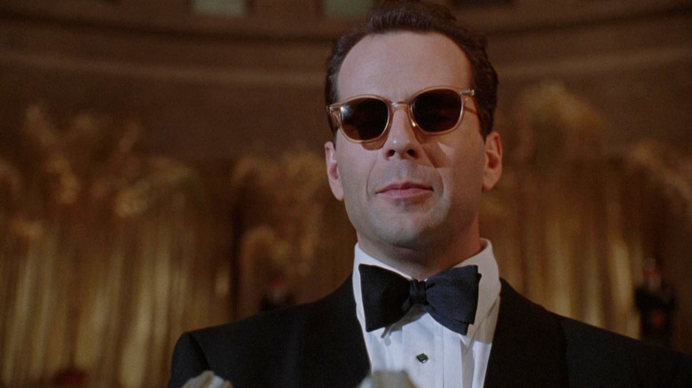 Bruce Willis as Peter Fallow in a tuxedo and shades in The Bonfire of the Vanities