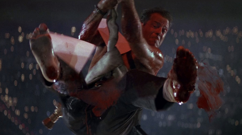 John McClane hangs from the side of Nakatomi Plaza in Die Hard