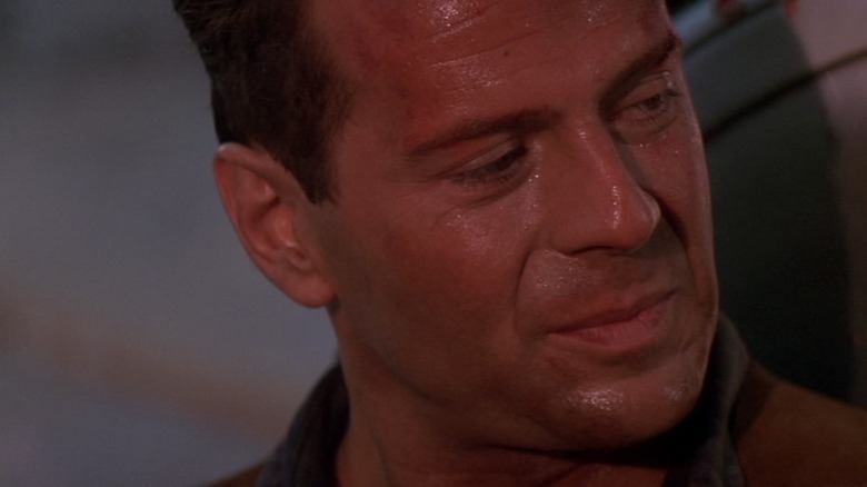 Bruce Willis' John McClane sweats as he looks to the right in Die Hard 2