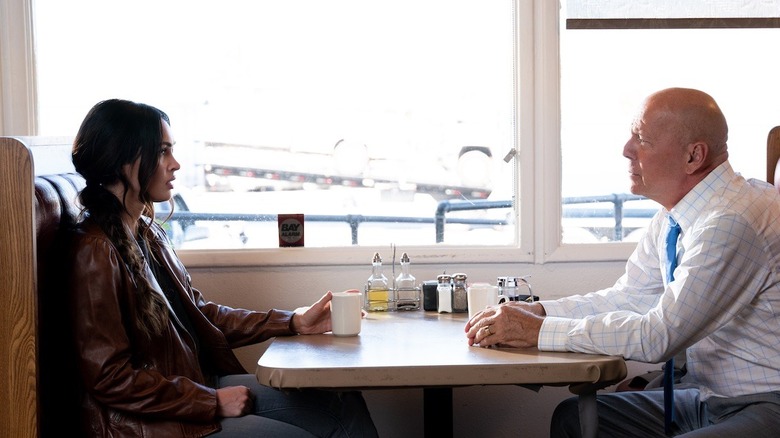 Rebecca and Karl sitting at a diner booth in Midnight in the Switchgrass