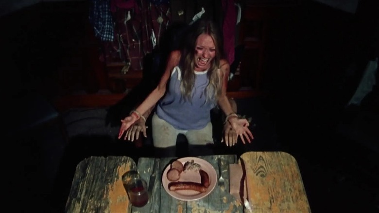 Sally tied to a chair with arms underneath her arms in The Texas Chain Saw Massacre 