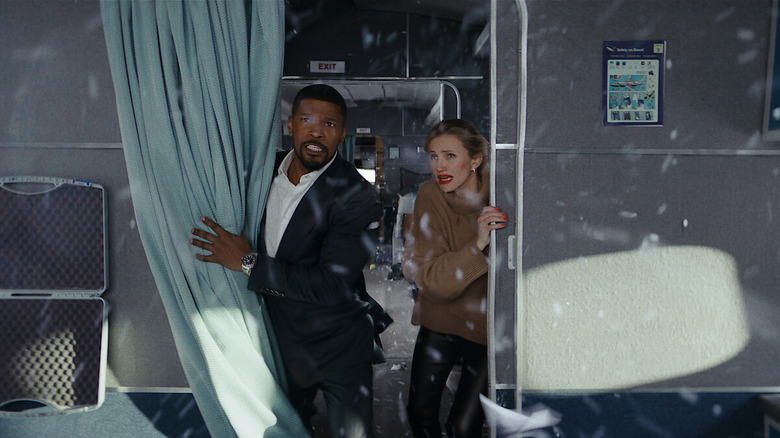 Jamie Foxx's Matt and Cameron Diaz's Emily stand in a plane as broken glass swirls around them in Back in Action