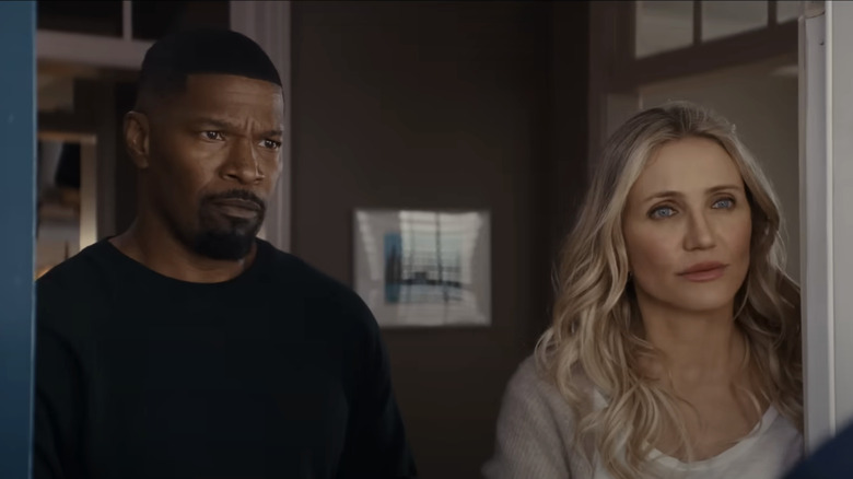 Jamie Foxx's Matt and Cameron Diaz's Emily stand in their doorway talking to a visitor in Back in Action