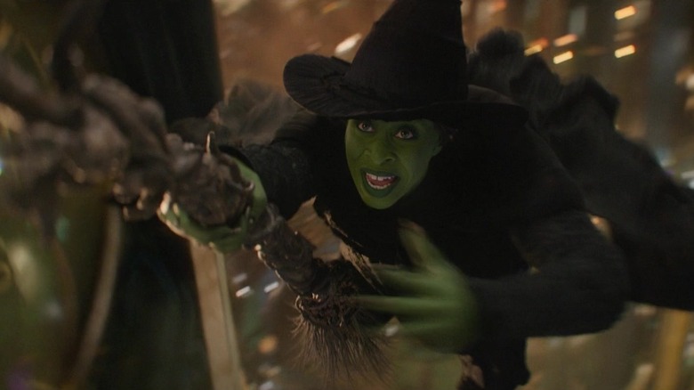 Elphaba riding her broomstick in Wicked