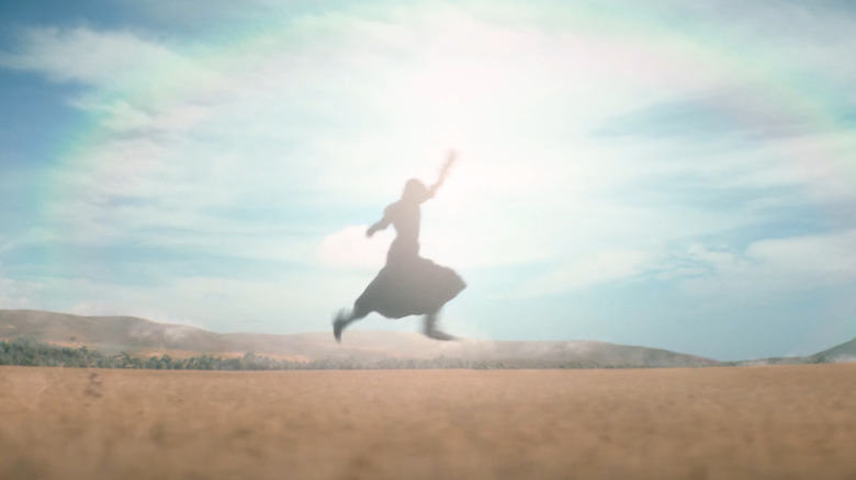 Elphaba running through a field in Wicked