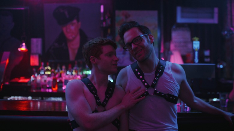 Pete (Brendan Scannell) and Josh (Theo Stockman) wearing harnesses at a bar on Bonding