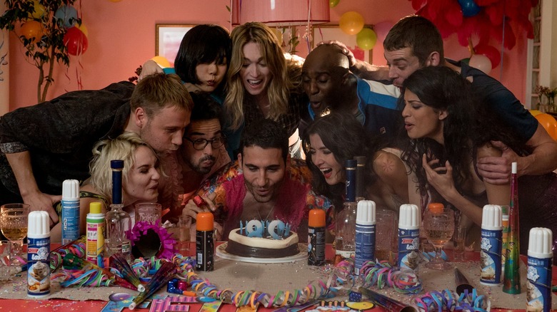 The cast of Sense8 gathered around a 28th birthday cake