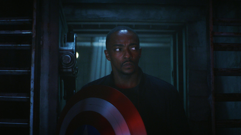 Anthony Mackie as Sam Wilson holding his shield in a mysterious bunker in Captain America: Brave New World