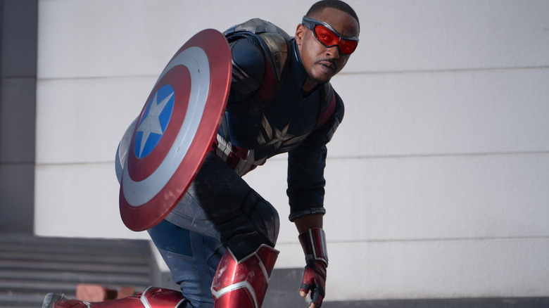 Anthony Mackie as Sam Wilson crouching with his shield in Captain America: Brave New World