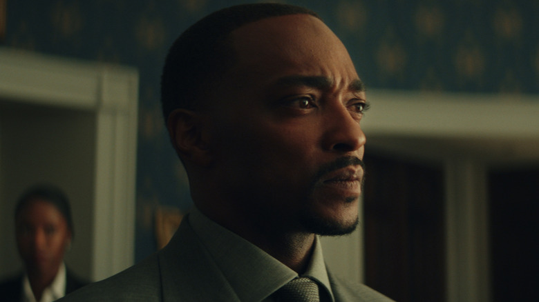 Sam Wilson looks worried while wearing a suit in Captain America: A brave new world