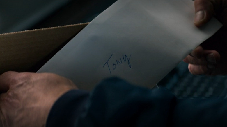 Tony takes a letter out of a Fed Ex box