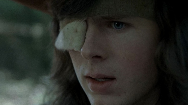 A close-up of Carl's (Chandler Riggs) worried face after he's bit by a walker in The Walking Dead