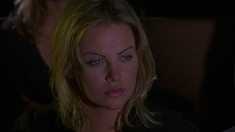 A random teen, played by Charlize Theron, looking at something in Children of the Corn III: Urban Harvest.