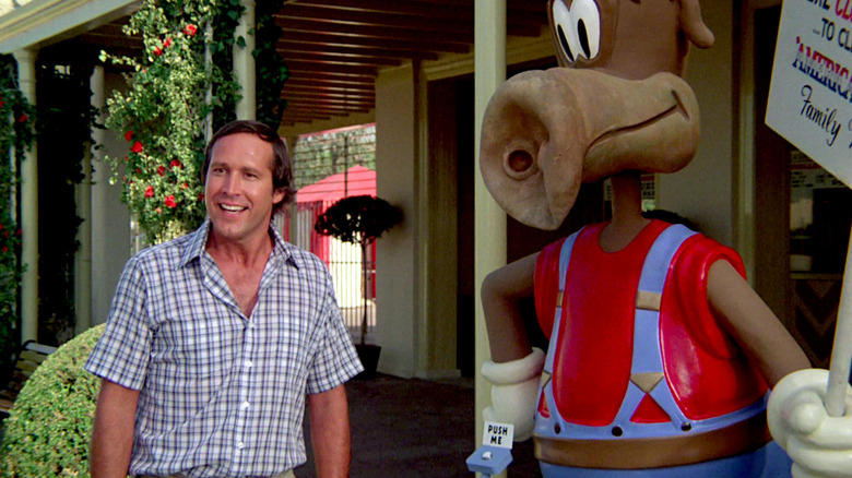 Chevy Chase stands next to the Wally World mascot in National Lampoon's Vacation