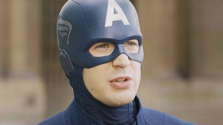 Chris Evans Captain America stands against a blurred background in The Avengers