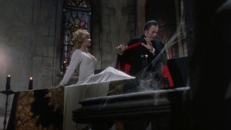 Christopher Lee as Dracula recoiling from a bosom protected by a crucifix in Dracula A.D. 1972