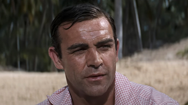 Sean Connery's James Bond sits on a beach in Thunderball