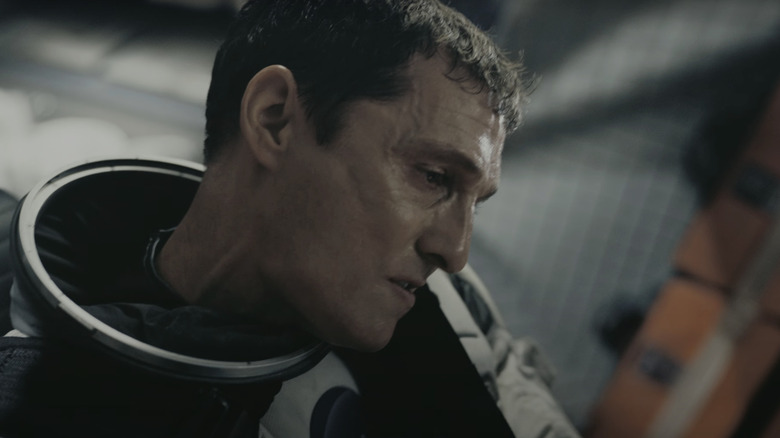 Matthew McConaughey's Joseph Cooper sits in a space shuttle looking down in Interstellar