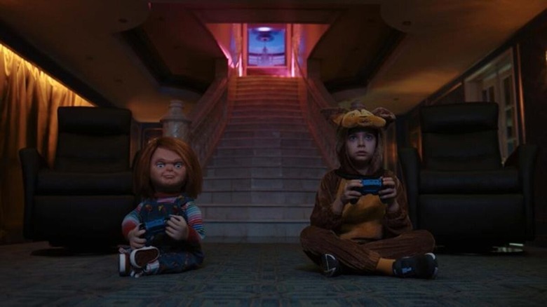 Caroline (Carina Battrick) and Chucky playing video games