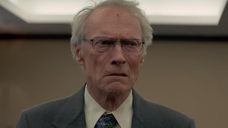 Clint Eastwood as Earl Stone wearing glasses and a suit in The Mule