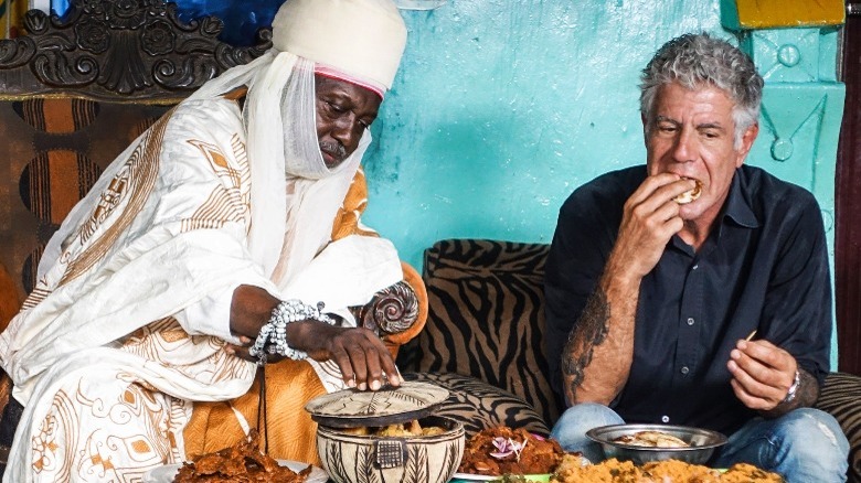 Bourdain eats alongside man