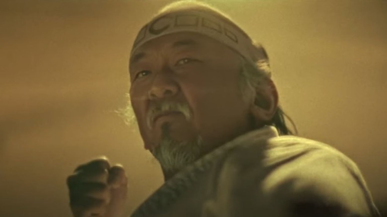 An AI version of Pat Morita's Mr. Miyagi raises a fist on Cobra Kai