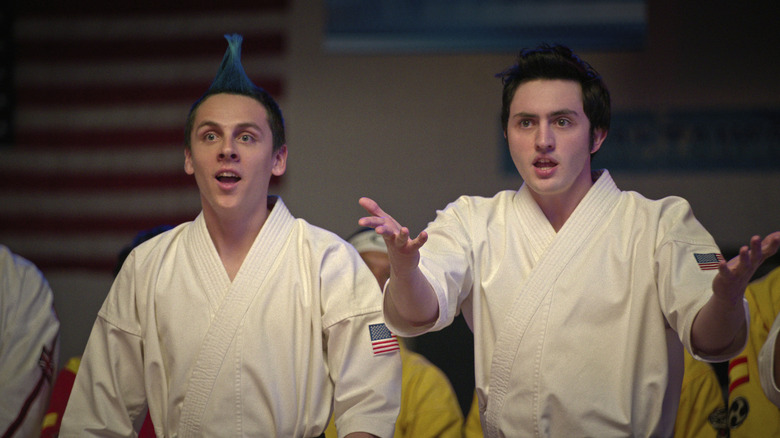 Hawk and Demetri wearing white gi and talking excitedly