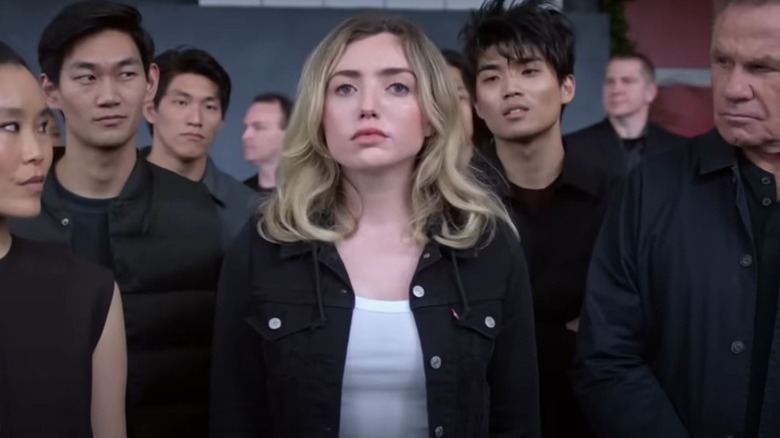 Peyton List's Tory Nichols surrounded by Cobra Kai members on Cobra Kai