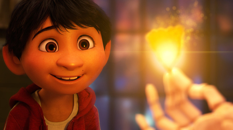 Miguel staring in wonder at a fiery flower in Coco