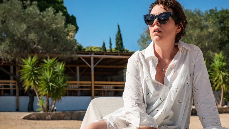 Olivia Colman sits, wearing sunglasses