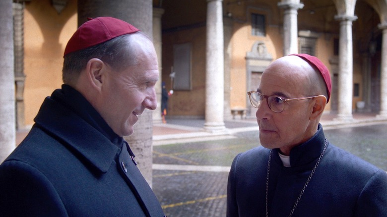 Lawrence and Bellini talking in the courtyard in Conclave