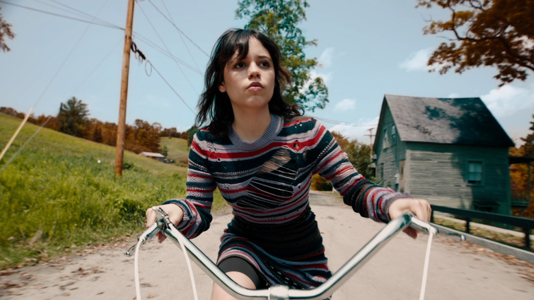 Jenna Ortega as Astrid riding her bike in Beetlejuice Beetlejuice