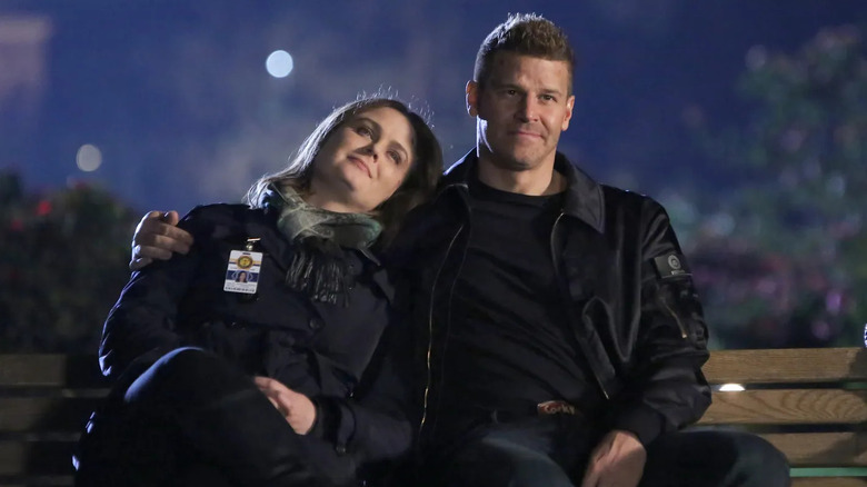 Bones and Booth cuddling on park bench Bones