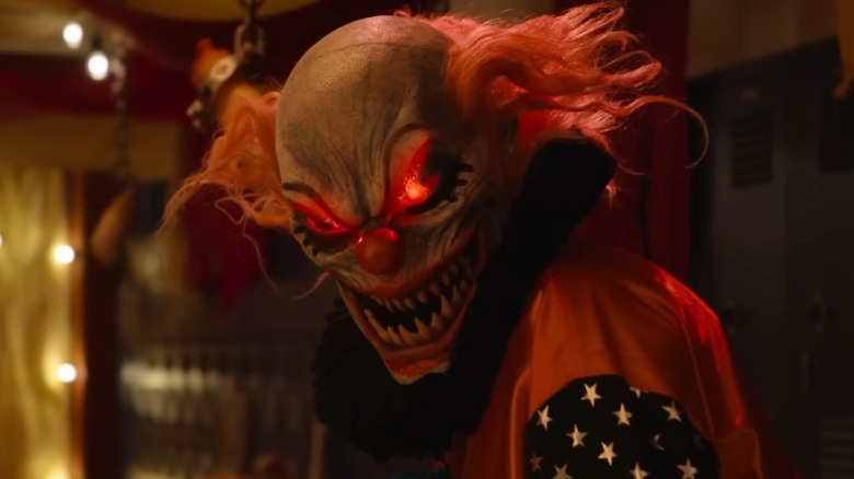 Evil clown with glowing red eyes