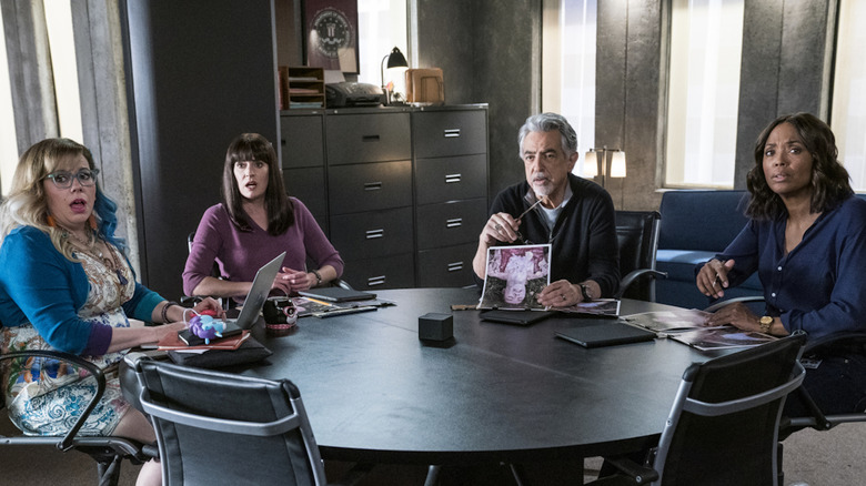 The BAU team sits around a table reviewing evidence