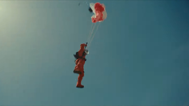 Brad Pitt in an orange astronaut suit parachuting
