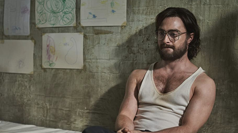 Daniel Radcliffe as Tim Jenkin sitting in his prison cell