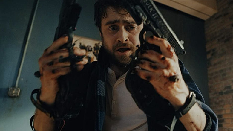 Daniel Radcliffe looking at his gun-bolted hands