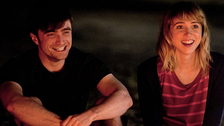 Daniel Radcliffe and Zoe Kazan sitting by the fire