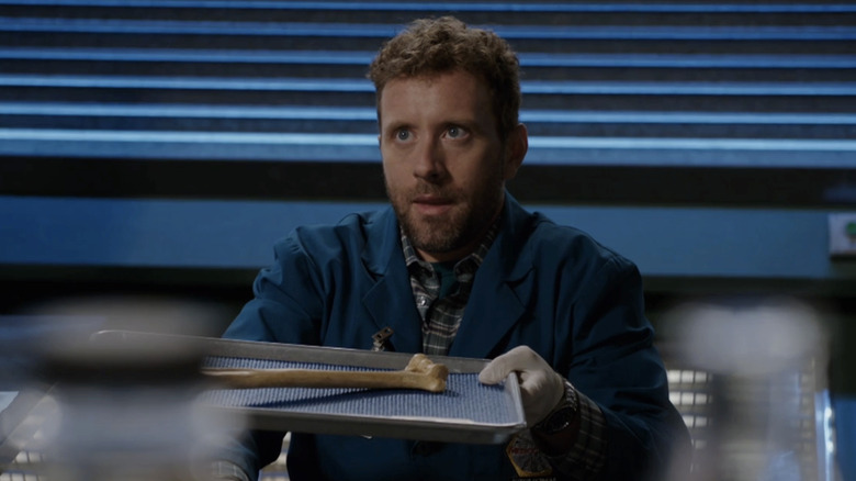 Jack Hodgins holds a tray with a bone on it in Bones