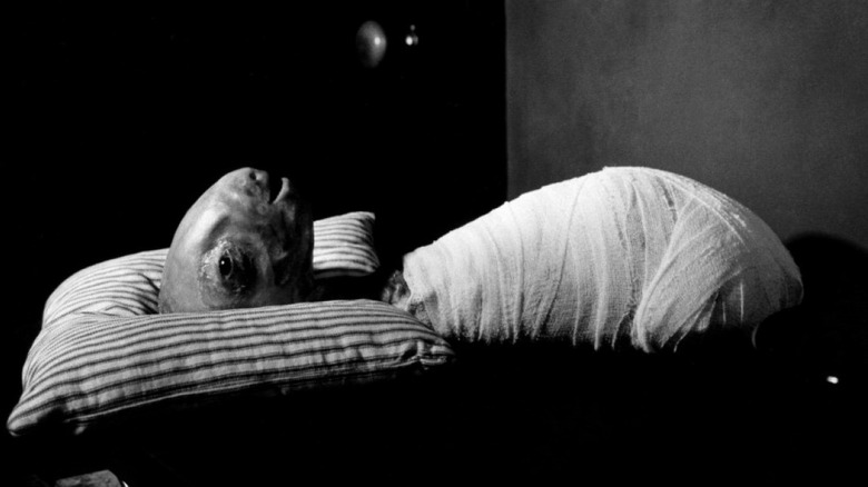 An inhuman creature lying swaddled in bandages in David Lynch's Eraserhead