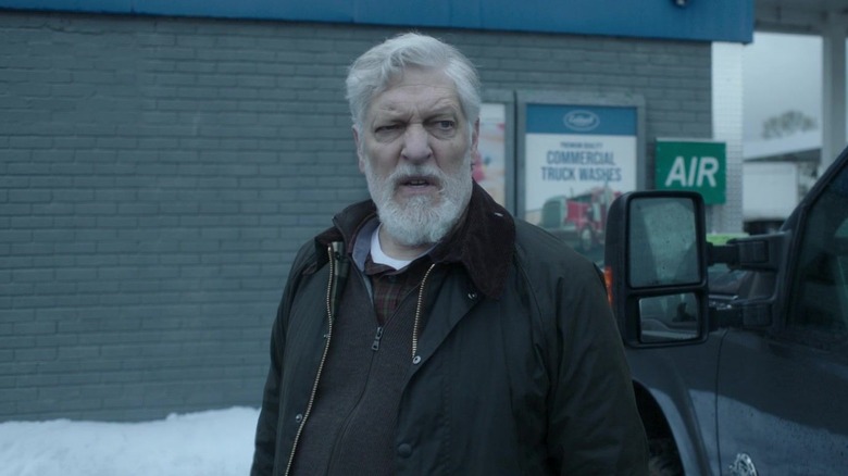 Clancy Brown as Kurt Caldwell (The Runaway Killer) looking upset outside a car wash on Dexter: New Blood