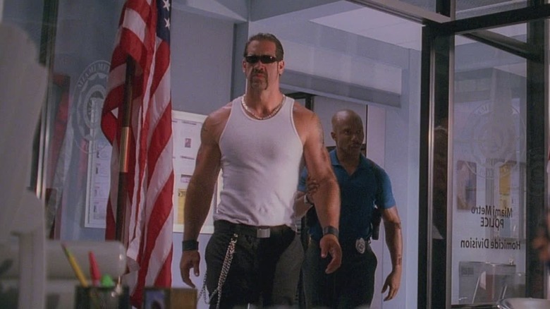 Matthew Willig as Little Chino, getting escorted through a police station on Dexter