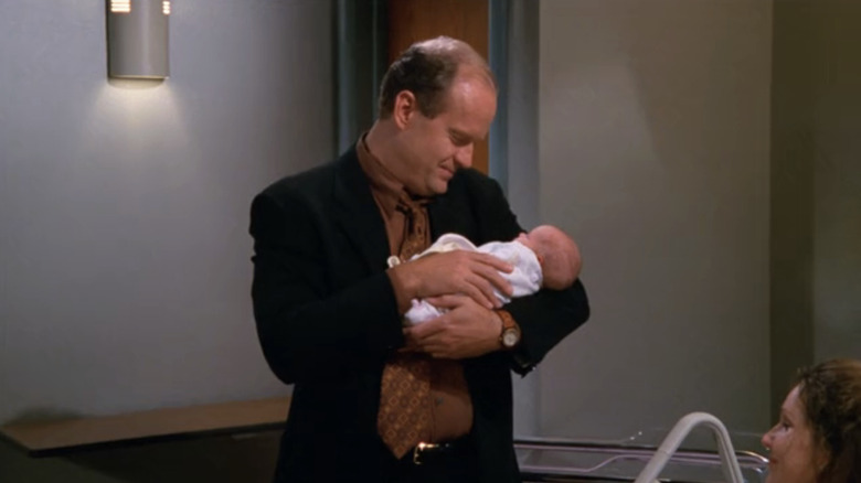 Kelsey Grammer's Frasier Crane holds a baby in Frasier