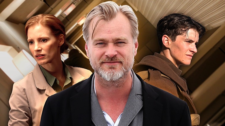 Christopher Nolan surrounded by Jessica Chastian's Murph from Interstellar and Fionn Whitehead's Tommy from Dunkrik