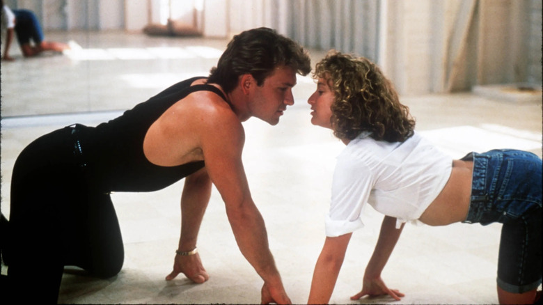 patrick swayze and jennifer grey crawling toward each other with their faces close in the movie dirty dancing