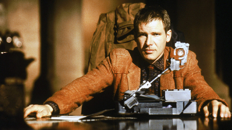 Rick Deckard, sitting next to his scanner, doing his job in Blade Runner